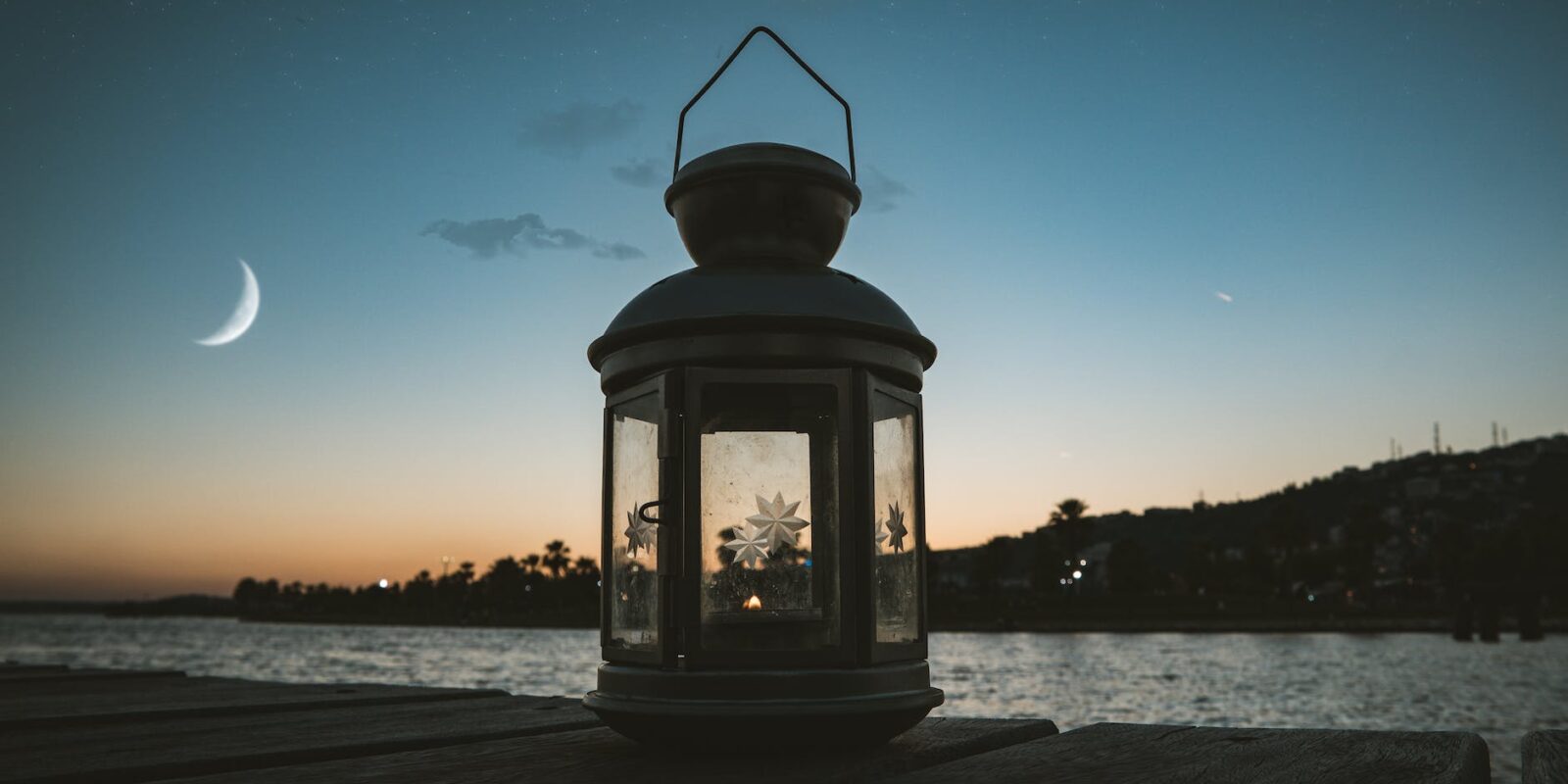 gray metal candle lantern on boat dock